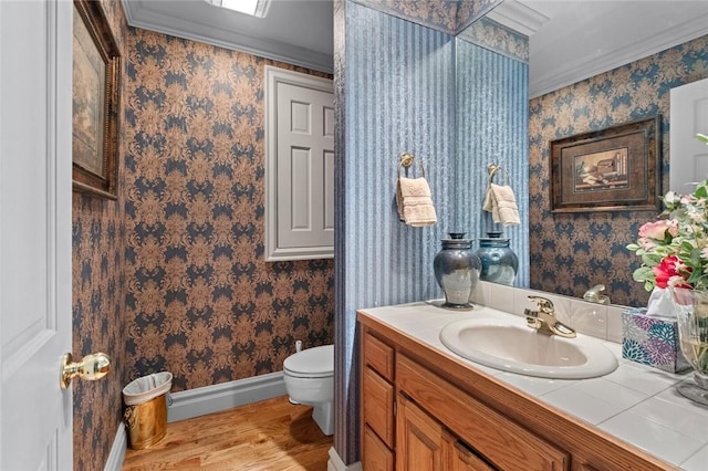 24 Dogwood Rdg, Eureka Springs, AR 72632 - bathroom featuring wood finished floors, baseboards, toilet, ornamental molding, and vanity