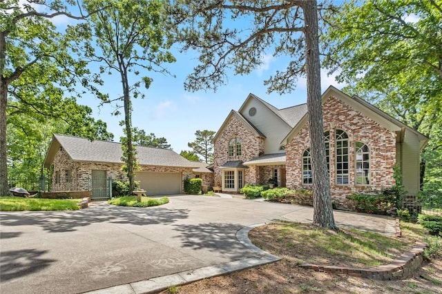 24 Dogwood Rdg, Eureka Springs, AR 72632 - view of front of house with an attached garage, concrete driveway, and brick siding