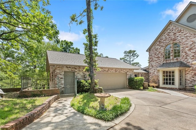 24 Dogwood Rdg, Eureka Springs, AR 72632 - view of front of house featuring driveway, a garage, fence, brick siding, and roof with shingles