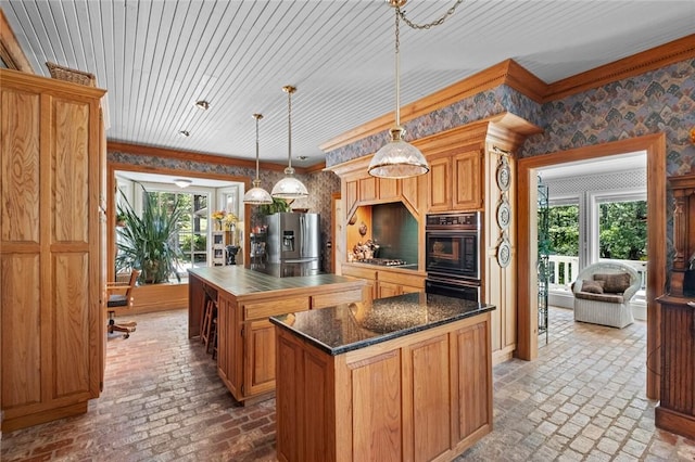 24 Dogwood Rdg, Eureka Springs, AR 72632 - kitchen featuring brick flooring, stainless steel appliances, a center island, wallpapered walls, and hanging light fixtures