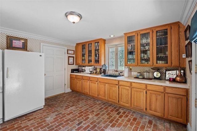 24 Dogwood Rdg, Eureka Springs, AR 72632 - kitchen featuring freestanding refrigerator, a sink, brick flooring, light countertops, and wallpapered walls