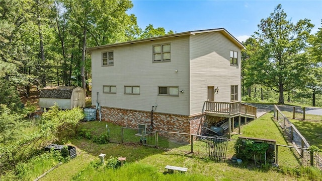 24 Dogwood Rdg, Eureka Springs, AR 72632 - rear view of house with a storage shed, an outbuilding, a wooden deck, brick siding, and central air condition unit