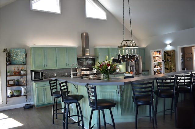 8141 Ward Ln, Rogers, AR 72756 - kitchen with exhaust hood, green cabinets, high vaulted ceiling, stainless steel appliances, and tasteful backsplash