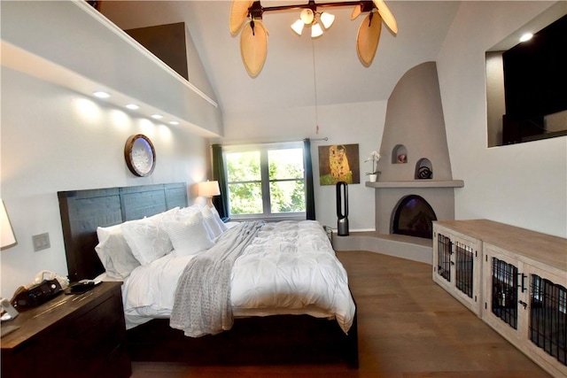 8141 Ward Ln, Rogers, AR 72756 - bedroom featuring wood finished floors, a fireplace, vaulted ceiling, and a ceiling fan