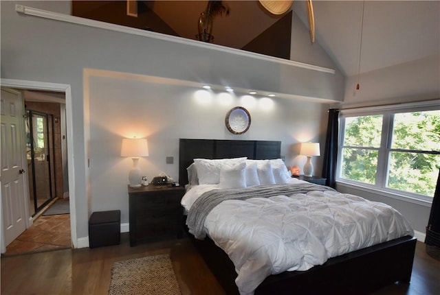 8141 Ward Ln, Rogers, AR 72756 - bedroom featuring lofted ceiling, multiple windows, baseboards, and wood finished floors