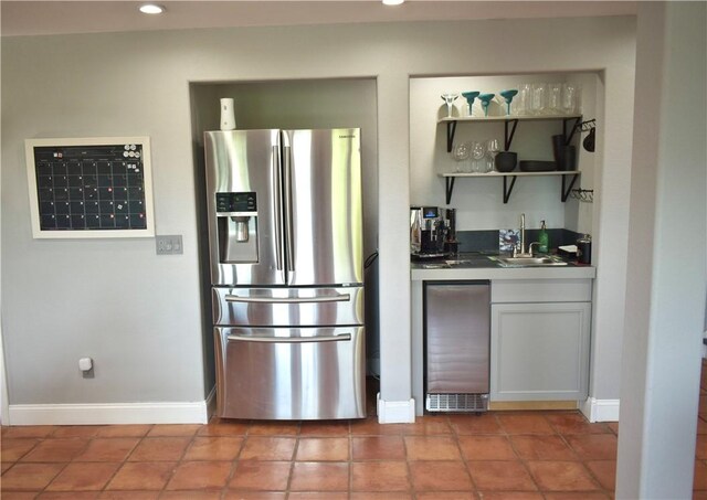 8141 Ward Ln, Rogers, AR 72756 - kitchen with stainless steel refrigerator with ice dispenser, a sink, baseboards, recessed lighting, and tile patterned flooring