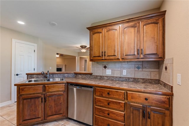 708 Carter Ct, Siloam Springs, AR 72761 - kitchen with stainless steel dishwasher, a sink, decorative backsplash, dark countertops, and a ceiling fan