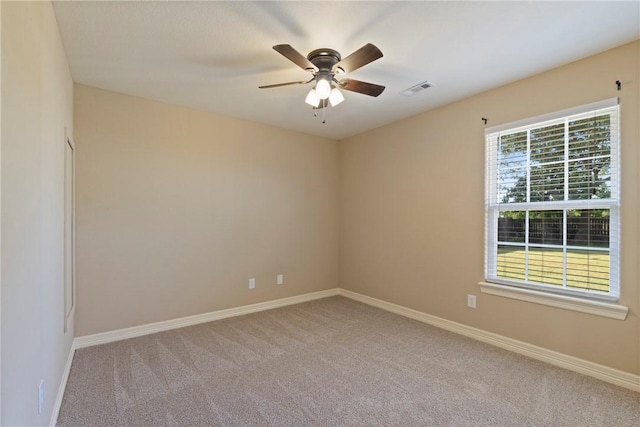 708 Carter Ct, Siloam Springs, AR 72761 - spare room featuring carpet flooring, baseboards, and a ceiling fan