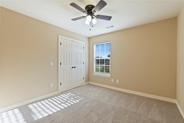 708 Carter Ct, Siloam Springs, AR 72761 - unfurnished bedroom featuring light carpet, baseboards, a closet, and ceiling fan