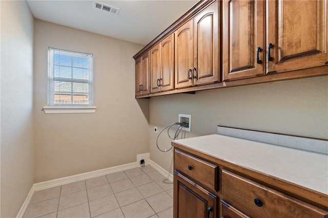 708 Carter Ct, Siloam Springs, AR 72761 - clothes washing area with electric dryer hookup, cabinet space, washer hookup, and baseboards