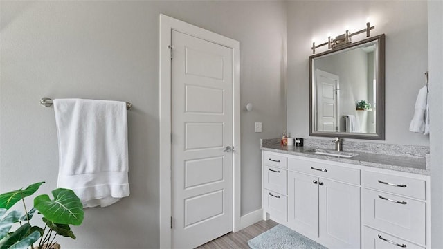1404 Breeze Ct, Bentonville, AR 72713 - bathroom with vanity, wood finished floors, and baseboards