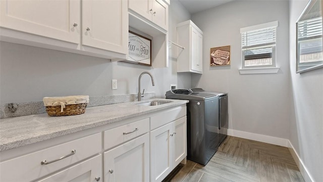 1404 Breeze Ct, Bentonville, AR 72713 - washroom featuring washing machine and clothes dryer, cabinet space, and baseboards