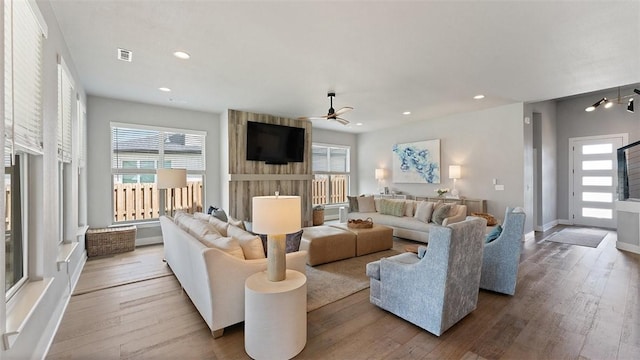1404 Breeze Ct, Bentonville, AR 72713 - living room featuring healthy amount of natural light, a ceiling fan, wood finished floors, and recessed lighting
