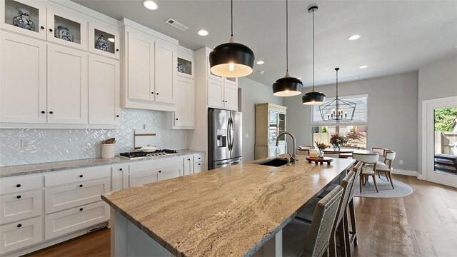 1404 Breeze Ct, Bentonville, AR 72713 - kitchen featuring appliances with stainless steel finishes, a sink, a kitchen island with sink, recessed lighting, and decorative backsplash
