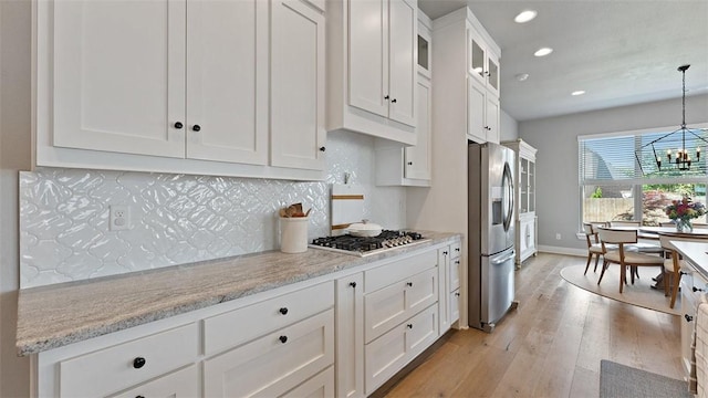 1404 Breeze Ct, Bentonville, AR 72713 - kitchen featuring stainless steel appliances, recessed lighting, white cabinetry, a chandelier, and light wood finished floors