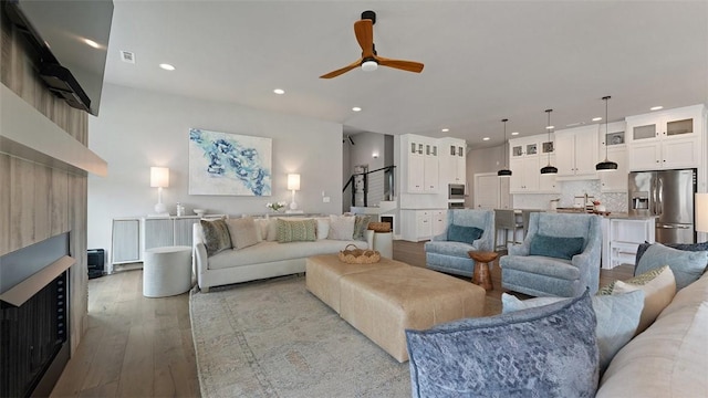 1404 Breeze Ct, Bentonville, AR 72713 - living area with hardwood / wood-style flooring, a ceiling fan, recessed lighting, and stairway