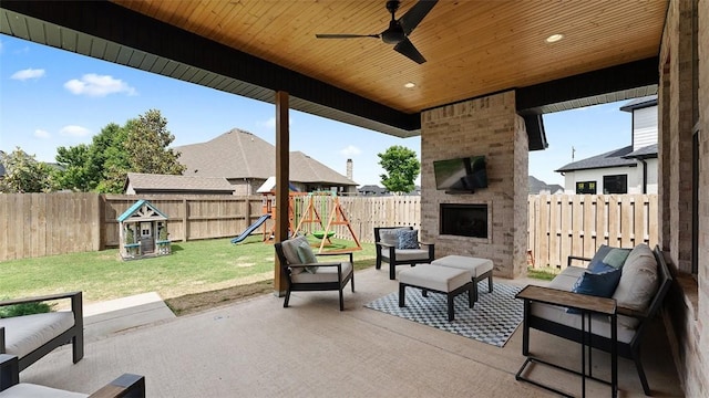 1404 Breeze Ct, Bentonville, AR 72713 - view of patio featuring an outdoor living space with a fireplace, a playground, and ceiling fan