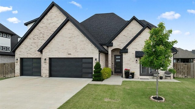 1404 Breeze Ct, Bentonville, AR 72713 - french country home featuring driveway, brick siding, and an attached garage