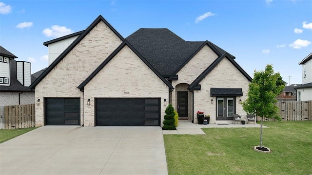 1404 Breeze Ct, Bentonville, AR 72713 - french country style house featuring french doors, concrete driveway, brick siding, and an attached garage