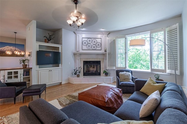 2507 NW Linebarger Ln, Bentonville, AR 72712 - living area featuring a fireplace, light wood-type flooring, and baseboards