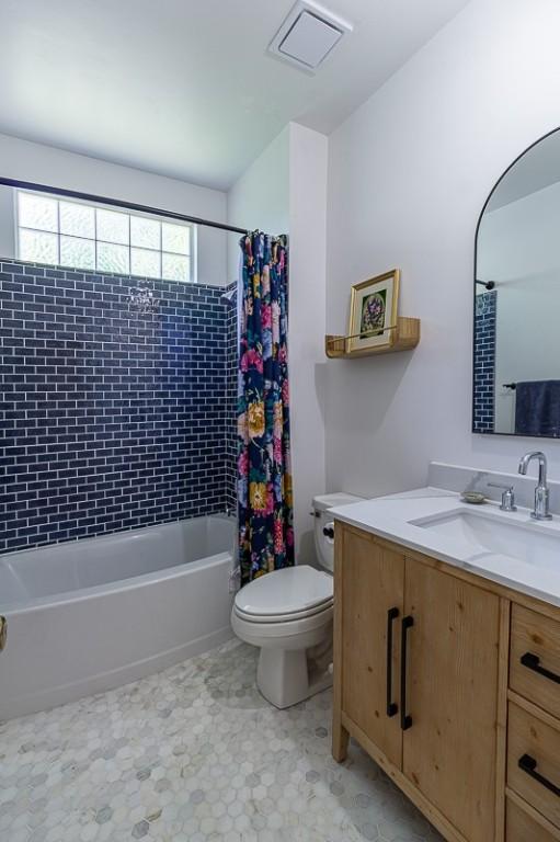 2507 NW Linebarger Ln, Bentonville, AR 72712 - bathroom with toilet, shower / bathtub combination with curtain, and vanity