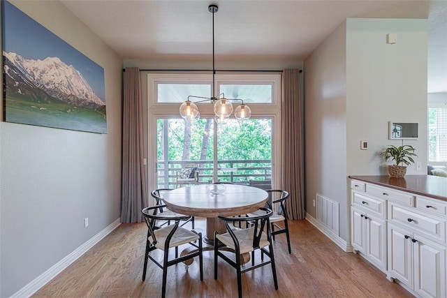 2507 NW Linebarger Ln, Bentonville, AR 72712 - dining area with light wood-style floors, a chandelier, and baseboards