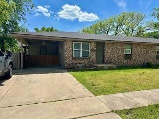 410 E Harvard St, Siloam Springs, AR 72761 - view of front of home with concrete driveway, a front lawn, and a carport