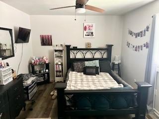 410 E Harvard St, Siloam Springs, AR 72761 - bedroom with dark wood-type flooring