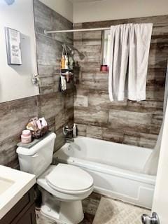 410 E Harvard St, Siloam Springs, AR 72761 - bathroom featuring tile walls, tub / shower combination, toilet, and vanity