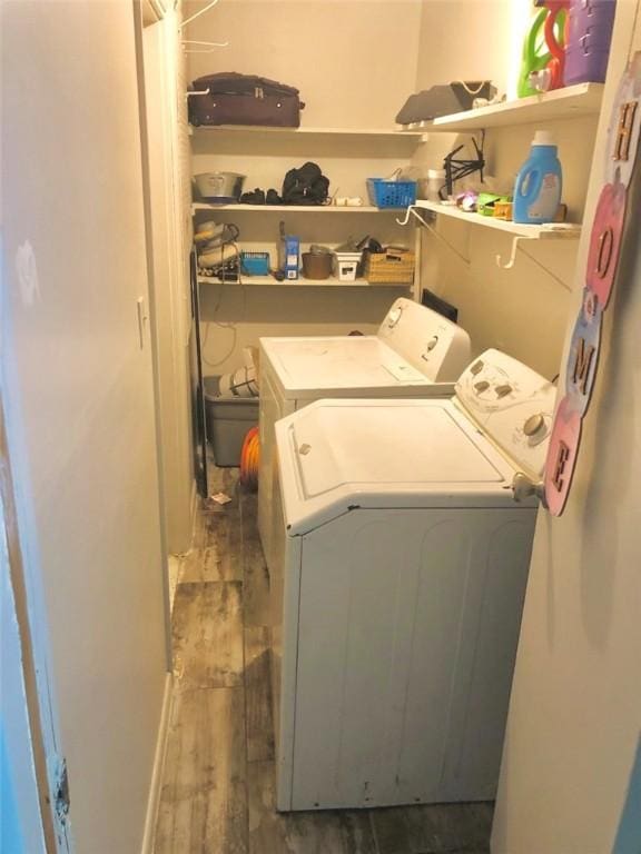 410 E Harvard St, Siloam Springs, AR 72761 - washroom featuring separate washer and dryer and wood finished floors