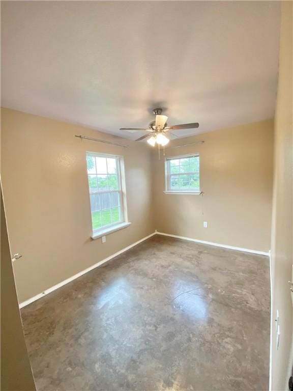 905 Durham Pl, Bentonville, AR 72712 - spare room with unfinished concrete floors, baseboards, and ceiling fan