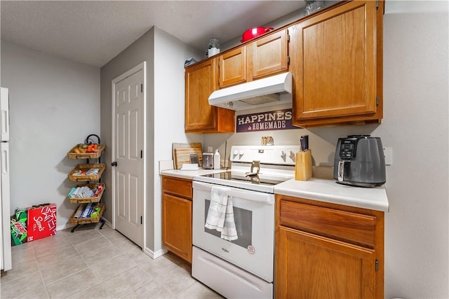 3408 SW Victoria Pl, Bentonville, AR 72712 - kitchen featuring white electric range oven, under cabinet range hood, light tile patterned floors, light countertops, and brown cabinetry