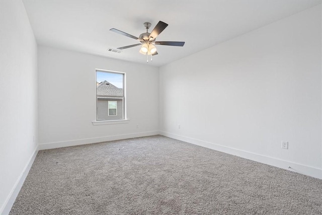 6601 SW Acacia St, Bentonville, AR 72713 - spare room featuring carpet floors, baseboards, and a ceiling fan