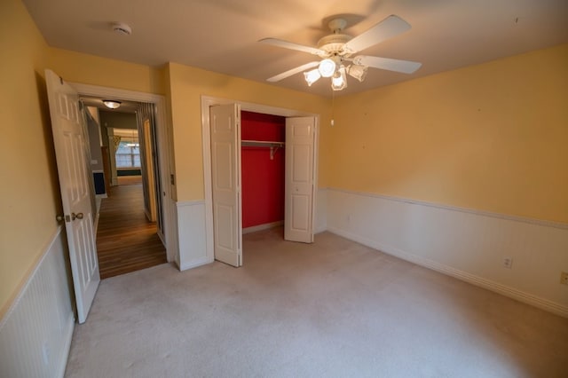 4509 W Highland Knolls Rd, Rogers, AR 72758 - unfurnished bedroom with light colored carpet, a closet, and ceiling fan