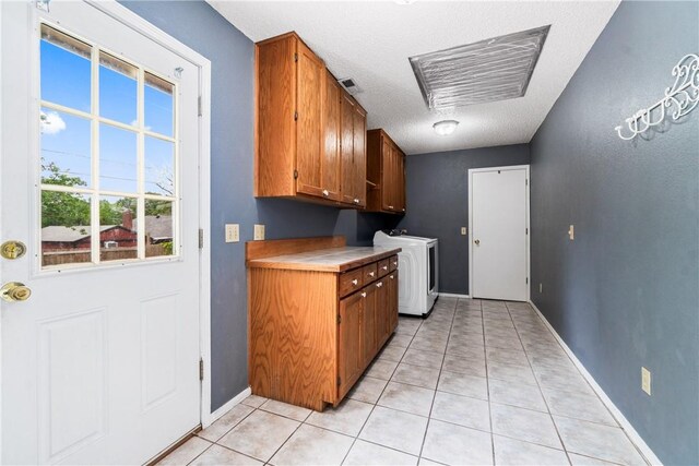 1502 Jennifer St, Springdale, AR 72762 - laundry room with cabinet space, washer / clothes dryer, a textured ceiling, baseboards, and light tile patterned floors
