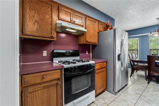 1502 Jennifer St, Springdale, AR 72762 - kitchen with range with gas cooktop, under cabinet range hood, stainless steel refrigerator with ice dispenser, brown cabinets, and a textured ceiling