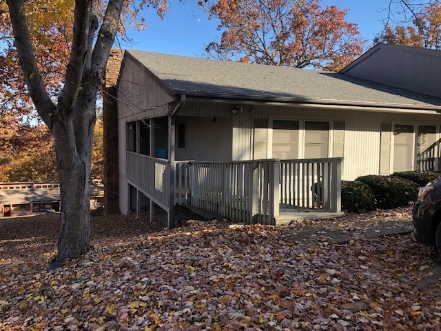 8 Mindy Ln, Bella Vista, AR 72715 - view of home's exterior featuring a chimney