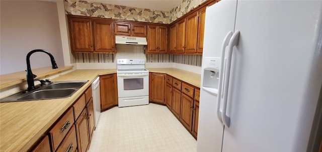 8 Mindy Ln, Bella Vista, AR 72715 - kitchen featuring white appliances, a sink, under cabinet range hood, brown cabinets, and light countertops