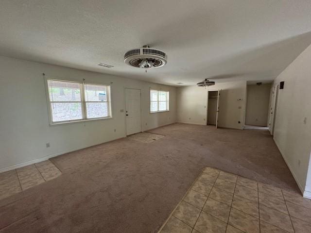 1376 Woods Point Rd, Elizabeth, AR 72531 - unfurnished living room featuring light carpet, light tile patterned floors, and baseboards