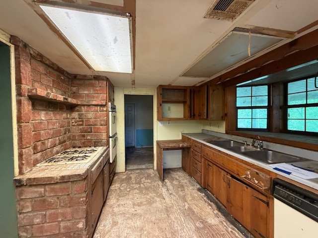 308 Flickinger St, Sulphur Springs, AR 72768 - kitchen with white appliances, open shelves, a sink, brown cabinetry, and brick wall