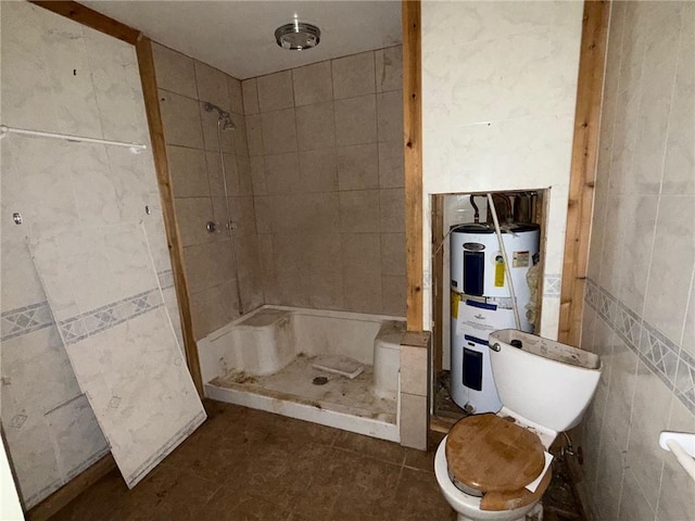 308 Flickinger St, Sulphur Springs, AR 72768 - bathroom featuring tile walls, electric water heater, a stall shower, toilet, and tile patterned flooring