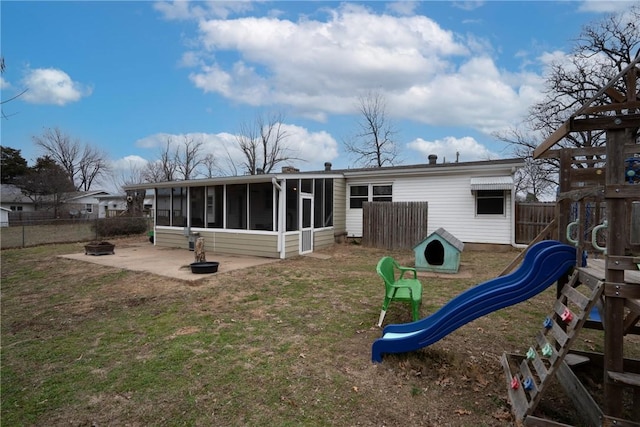 928 S Maple St, Siloam Springs, AR 72761 - back of house featuring a sunroom and a playground