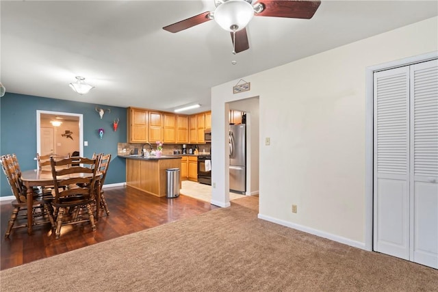 928 S Maple St, Siloam Springs, AR 72761 - dining space with carpet, baseboards, and ceiling fan