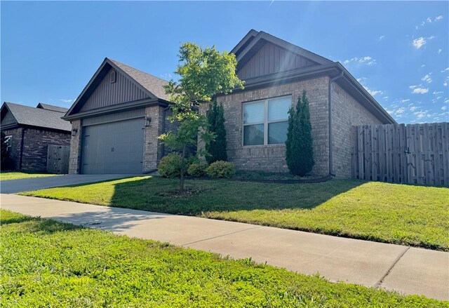 575 N Drewrys Bluff Dr, Fayetteville, AR 72704 - view of front facade featuring brick siding, a garage, driveway, and board and batten siding