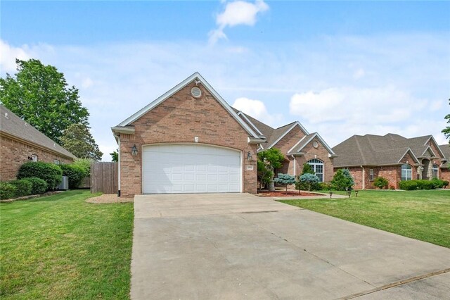 4005 Lyndale Dr, Rogers, AR 72758 - view of front facade with brick siding, concrete driveway, and a garage
