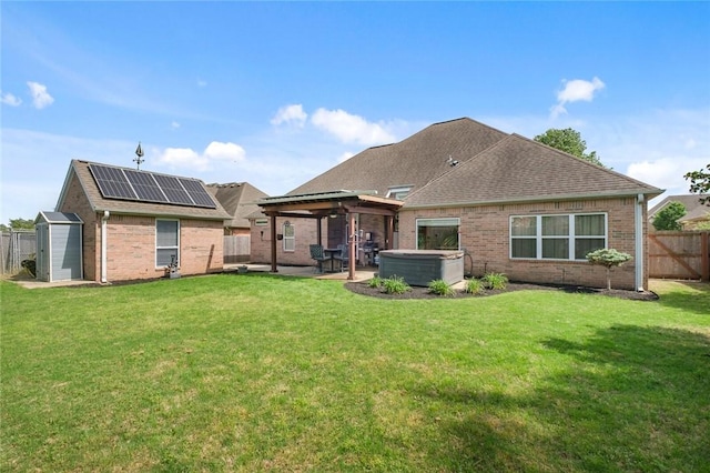 4005 Lyndale Dr, Rogers, AR 72758 - back of house featuring a hot tub, brick siding, a patio area, a gazebo, and solar panels