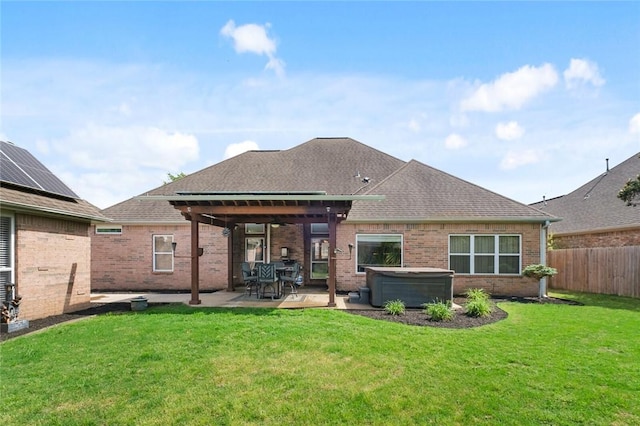 4005 Lyndale Dr, Rogers, AR 72758 - back of house with a hot tub, a patio, brick siding, and roof with shingles