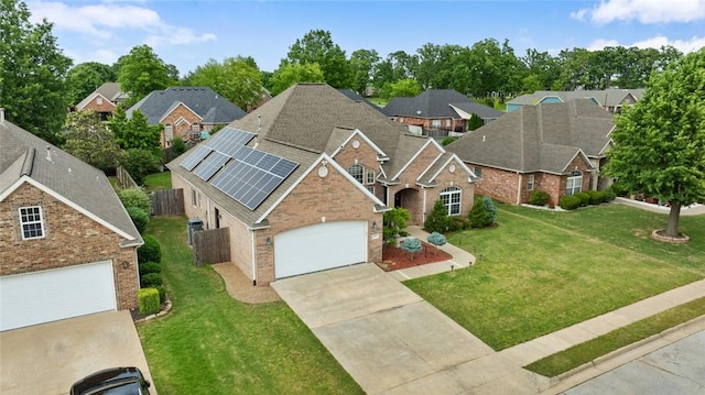 4005 Lyndale Dr, Rogers, AR 72758 - view of front of property featuring a shingled roof, driveway, roof mounted solar panels, and brick siding