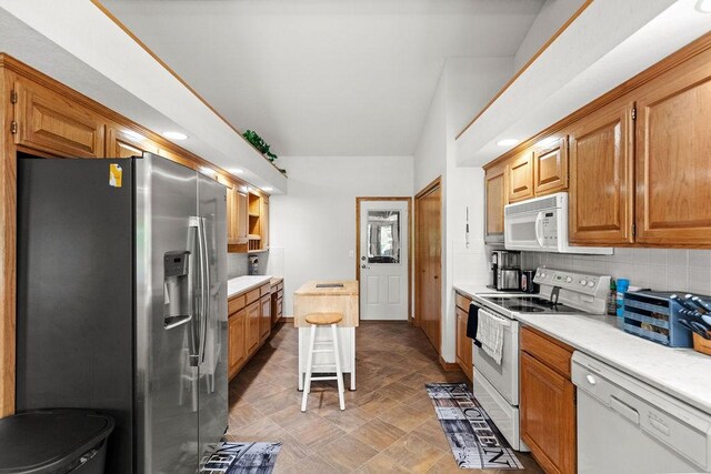 6 Portsmouth Ln, Bella Vista, AR 72715 - kitchen featuring white appliances, light countertops, backsplash, and brown cabinetry