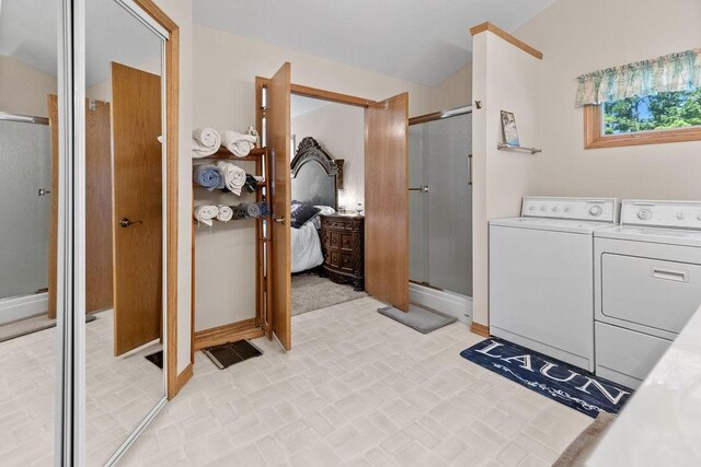 6 Portsmouth Ln, Bella Vista, AR 72715 - full bath featuring separate washer and dryer, baseboards, a shower stall, and brick patterned flooring
